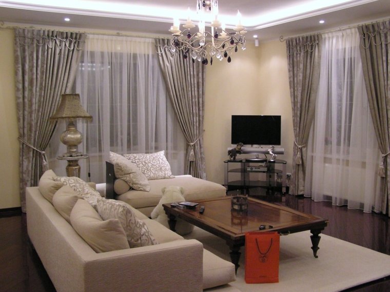 Интерьер угловой гостиной с двумя окнами