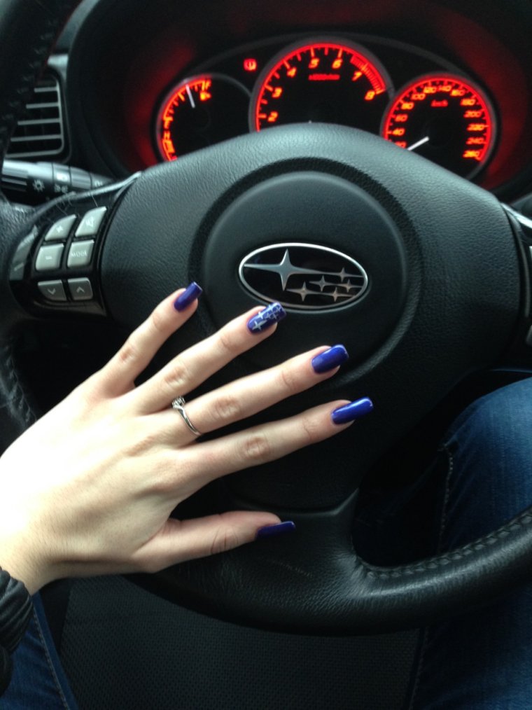 Женская рука на руле машины
