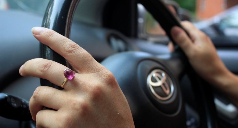 Женская рука на руле Тойоты