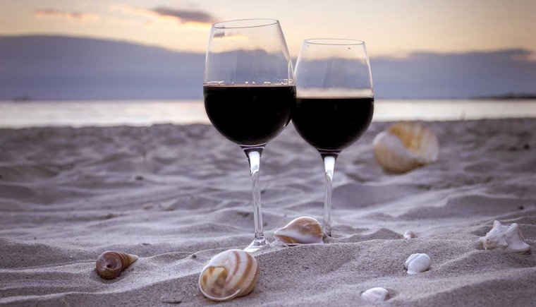 Два бокала вина на берегу моря