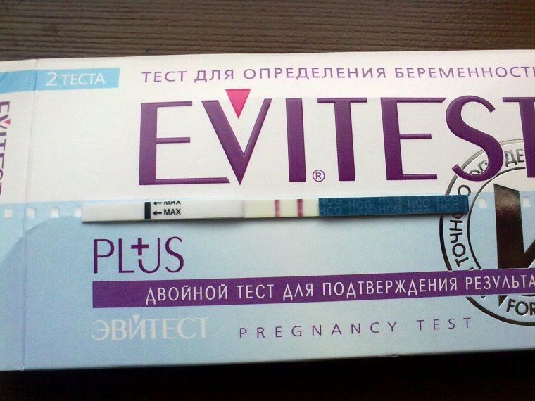 Девушка с тестом на беременность в руках
